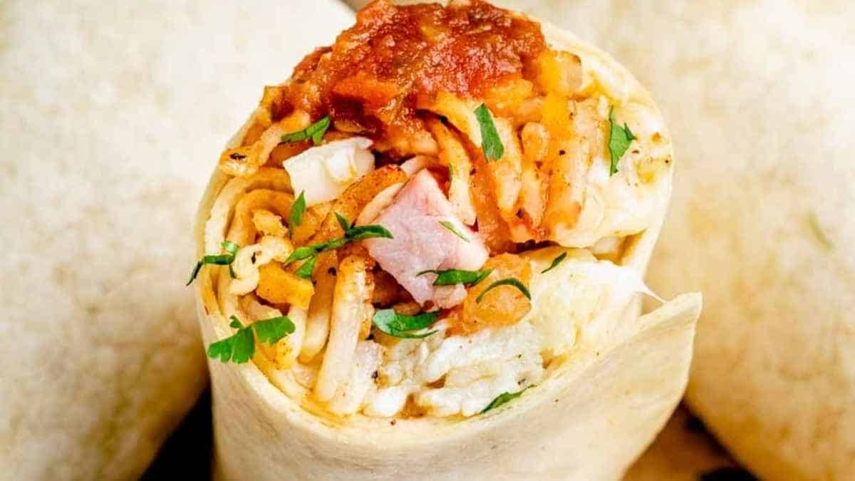 A burrito filled with meat and vegetables.