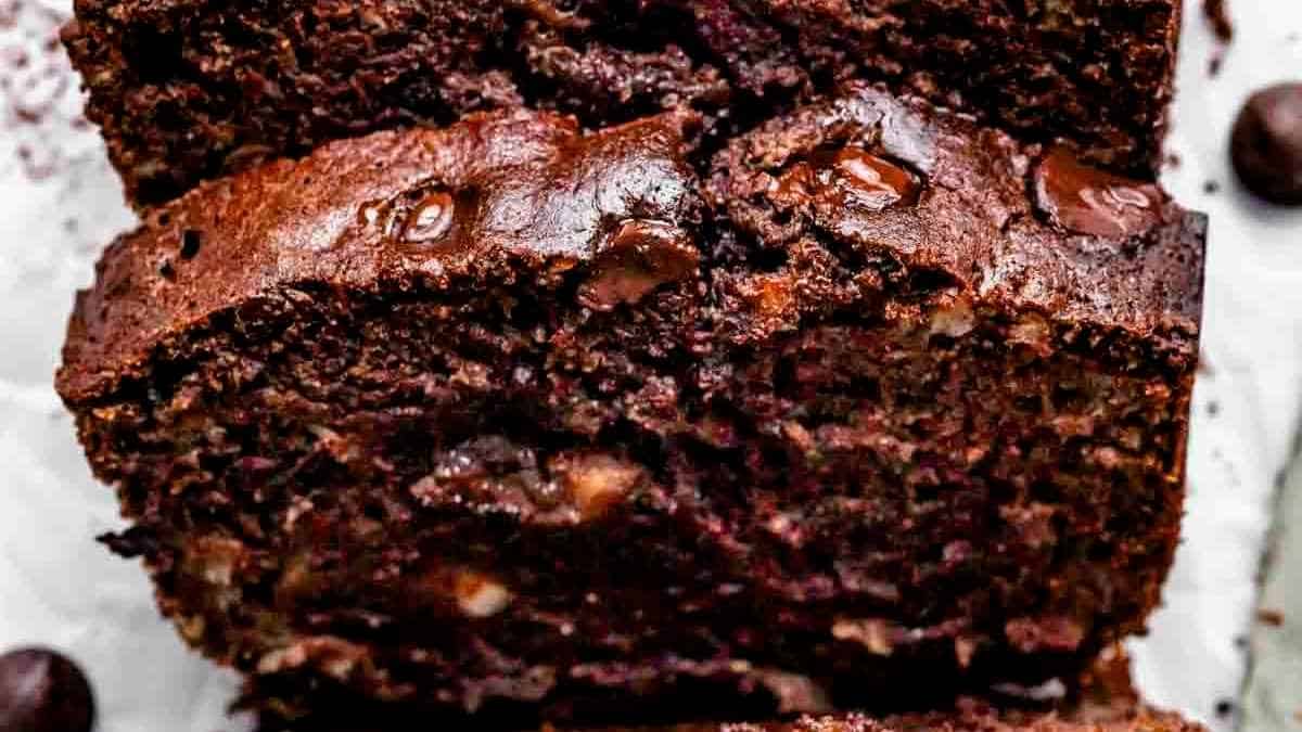 A slice of chocolate banana bread on a white plate.