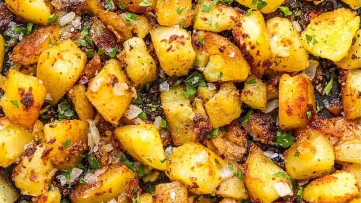 A close up of fried potatoes in a pan.