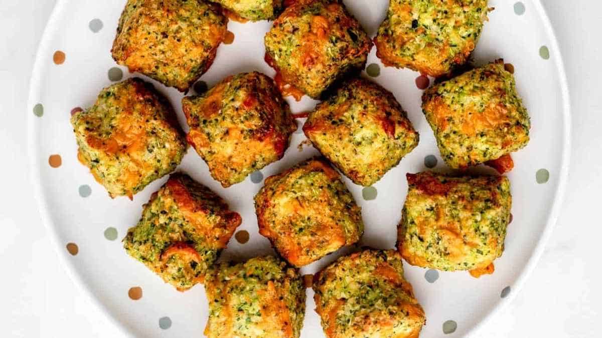 Cheesy broccoli bites on a plate with polka dots.