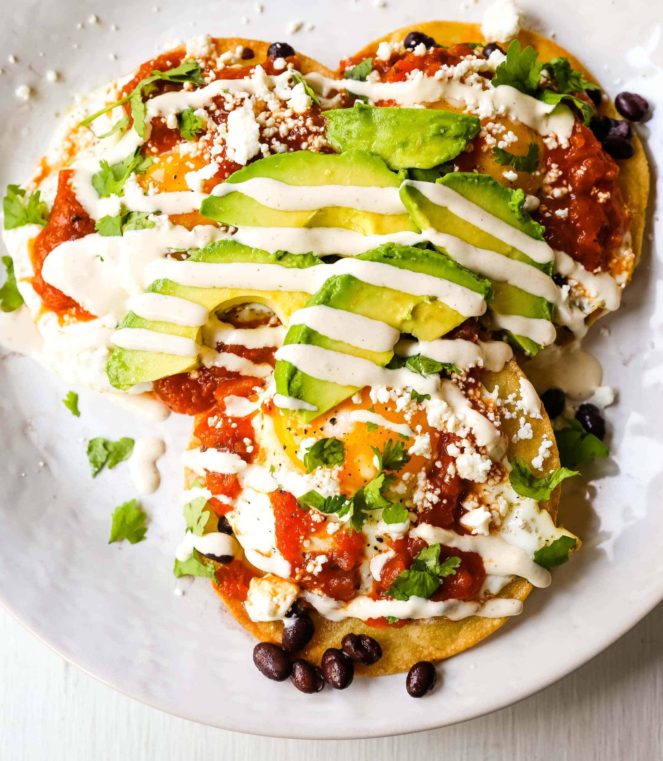 Huevos Rancheros. A traditional Mexican breakfast dish made with fried corn tortillas, fried egg, ranchera salsa, beans, avocado, cheese, and salsa.  
