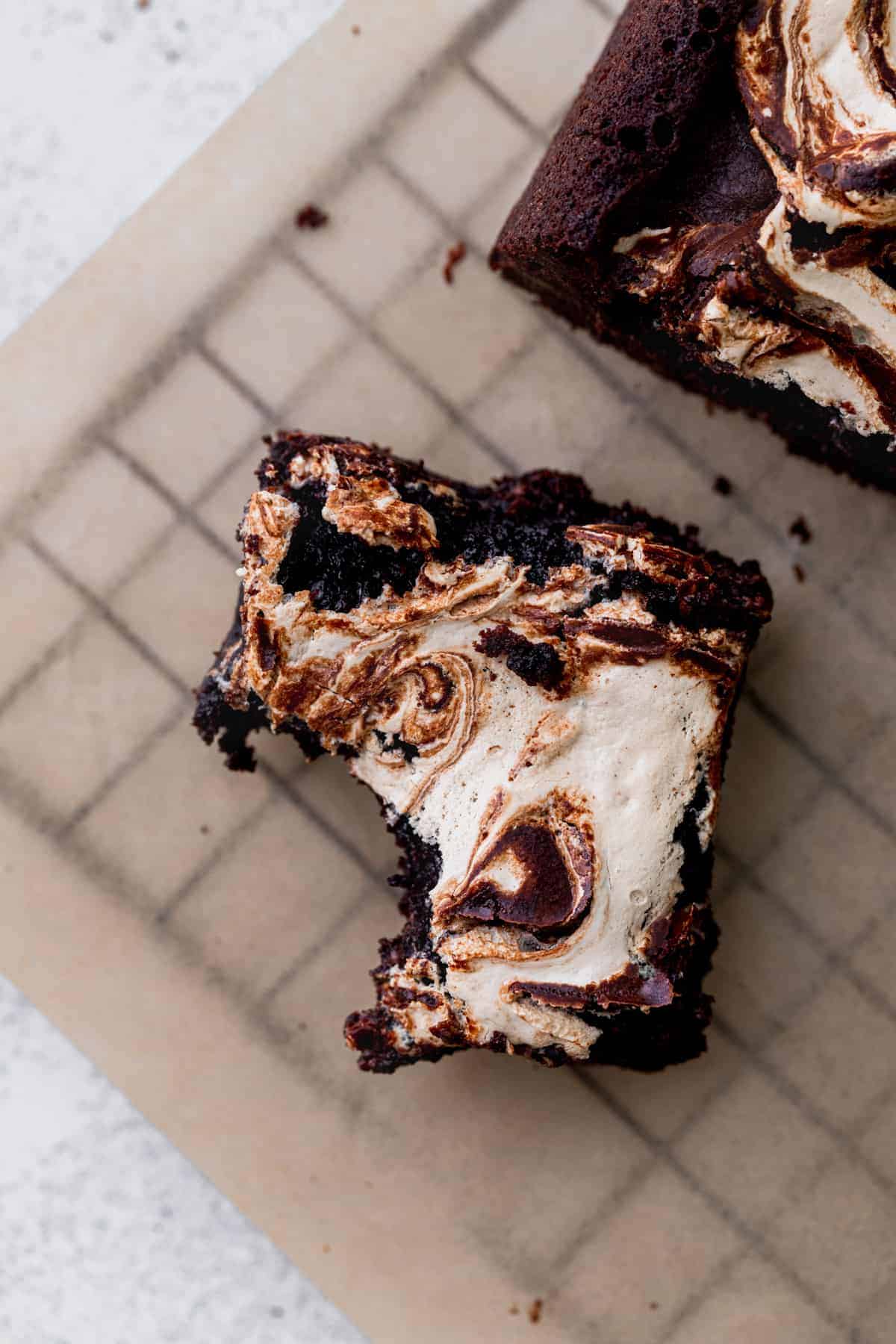 One bite missing from marshmallow brownies. 
