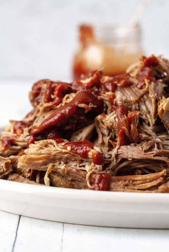 Bbq pulled pork on a white plate.