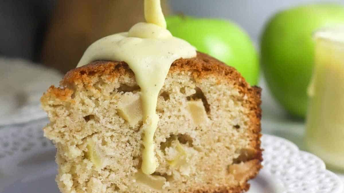 A slice of apple cake with a drizzle of icing.