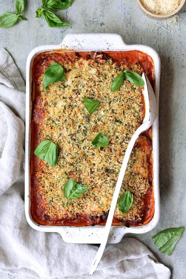 Photo of Italian Summer Vegetable Casserole baked and garnished with torn fresh basil. 
