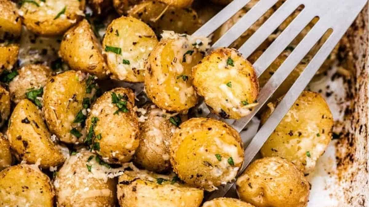 Parmesan roasted potatoes in a baking dish with a fork.