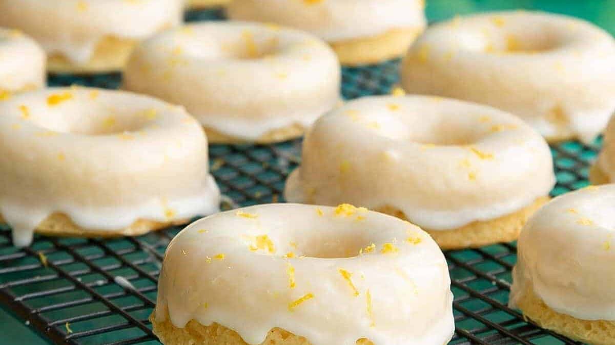 Lemon glazed donuts on a cooling rack.