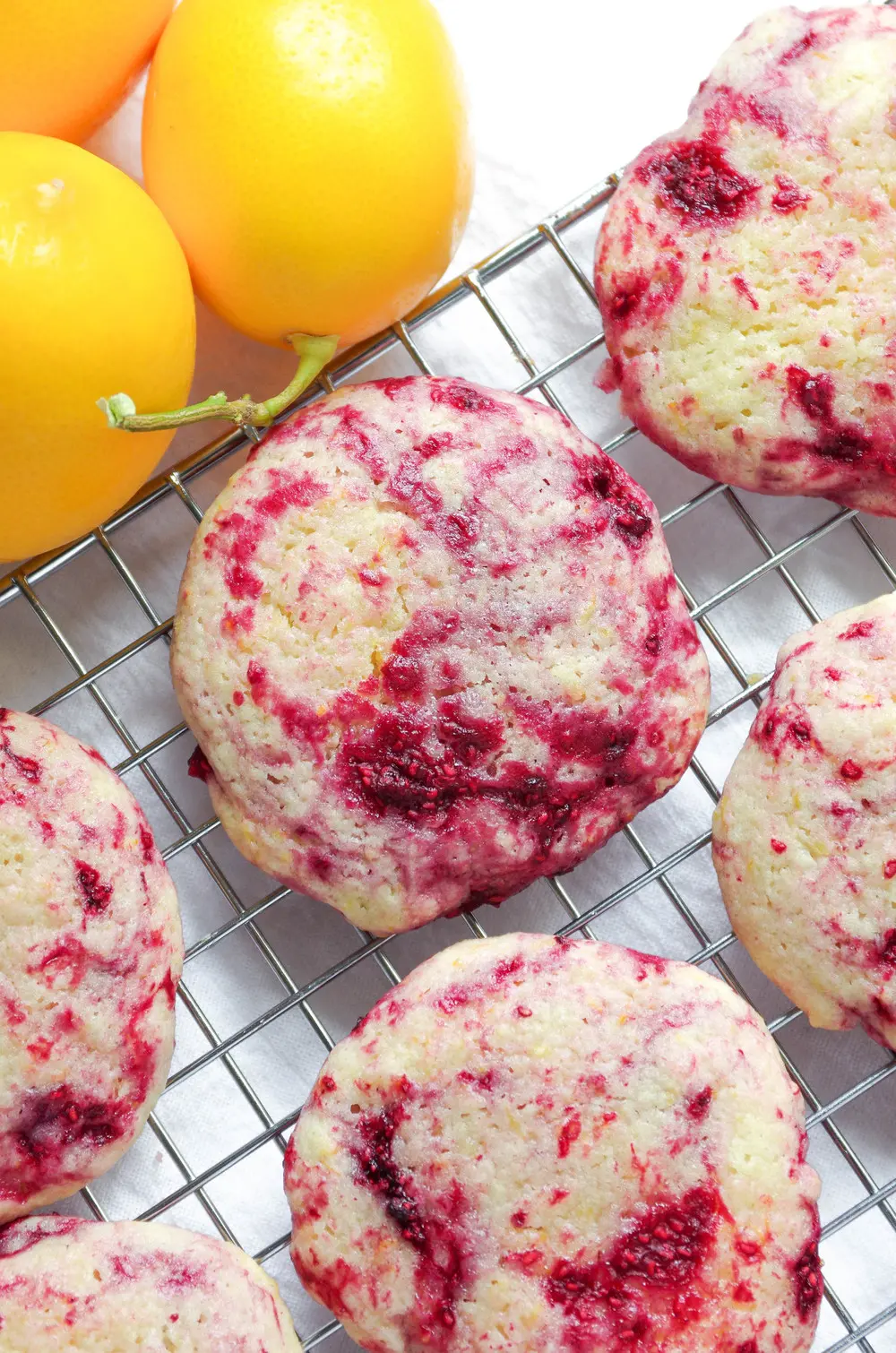 Unique raspberry lemon cookies on a cooling rack.
