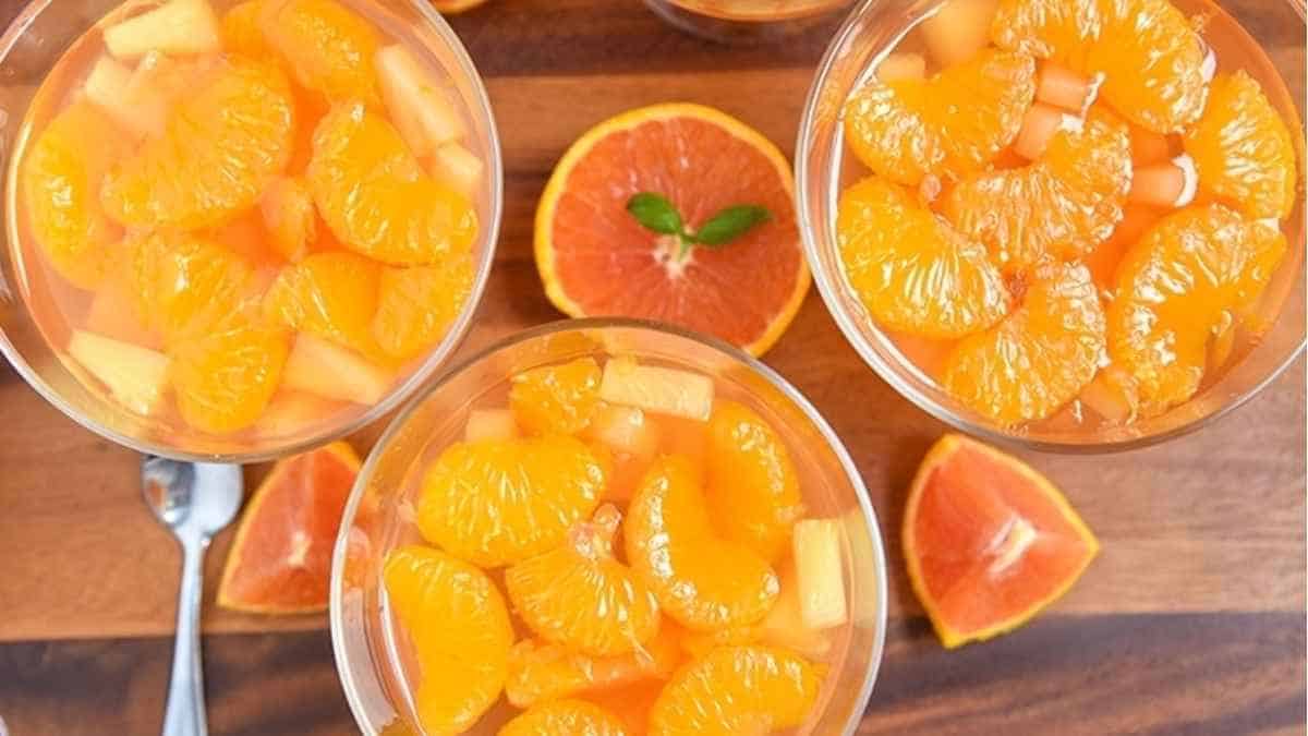 A bowl of orange juice with slices of oranges.
