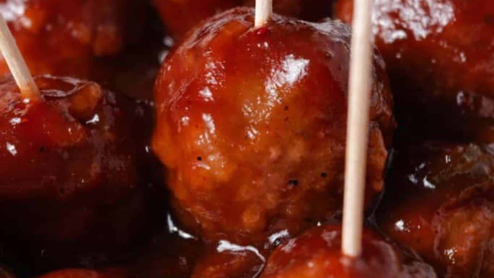Meatballs with toothpicks on a plate.