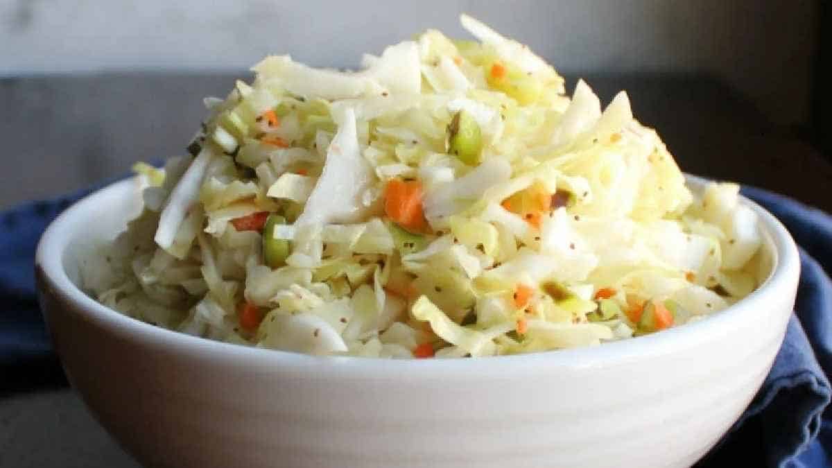 A bowl of cabbage slaw with carrots and celery.