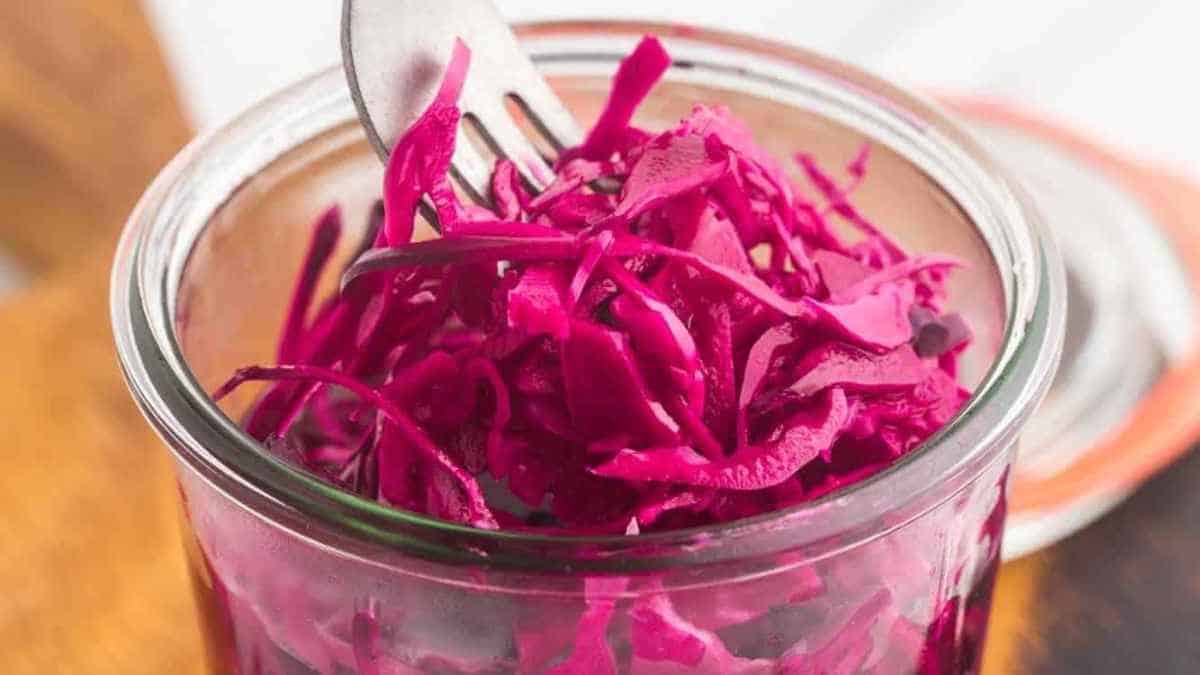 Red cabbage in a jar with a fork.
