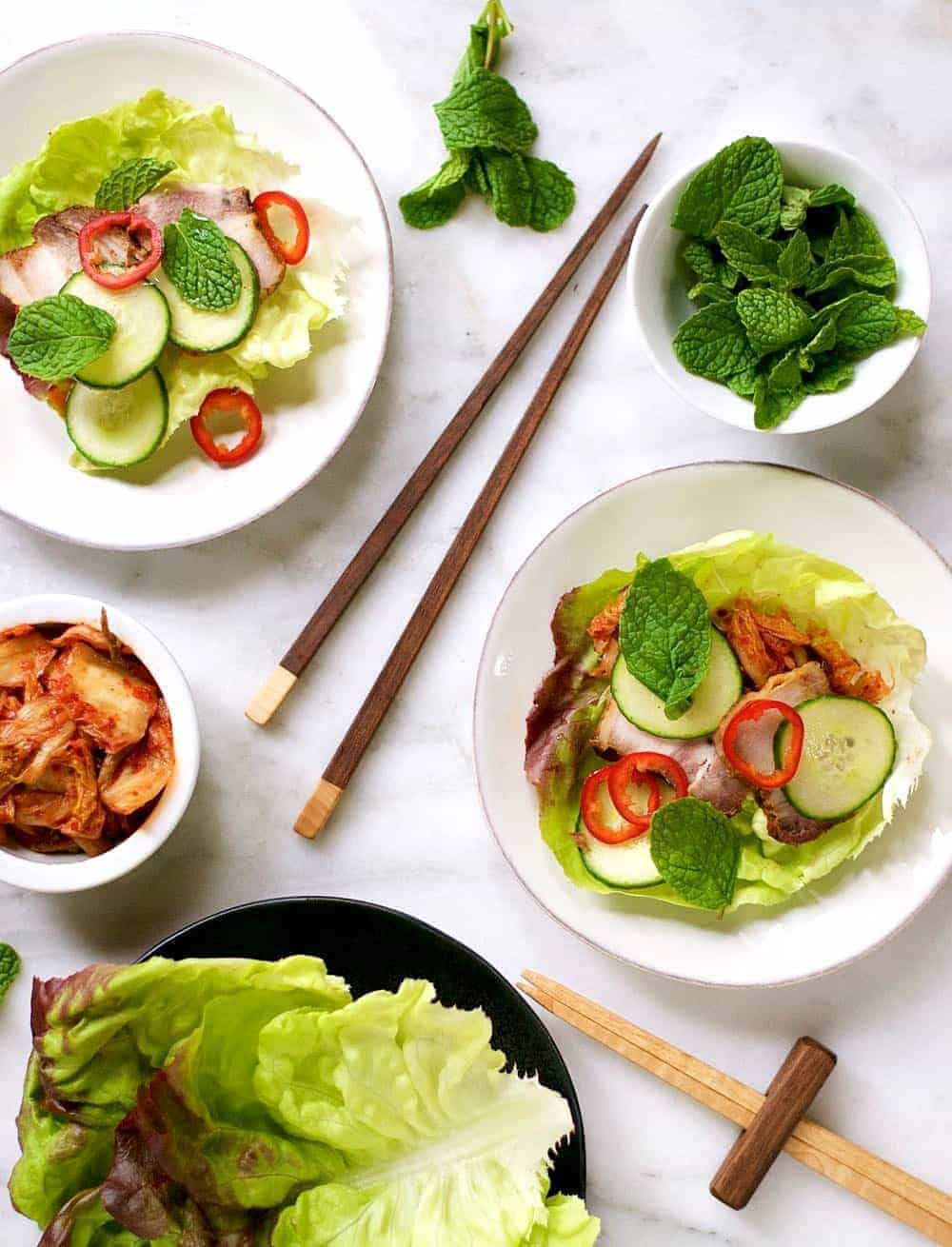 Asian lettuce wraps with pork belly, cucumber, and mint.