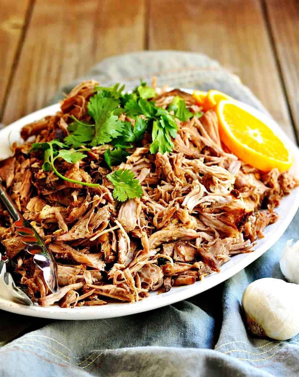 Slow Cooker Pork Carnitas served on a white oval platter 
