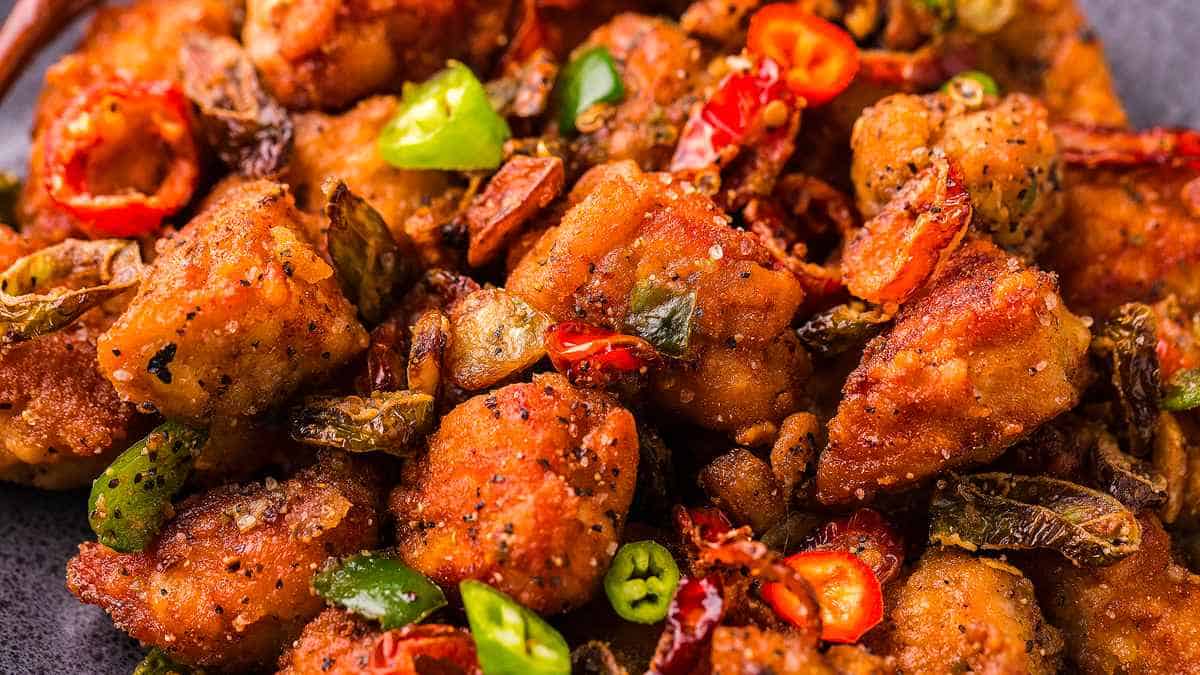 Chinese fried chicken with peppers and chilies on a plate.