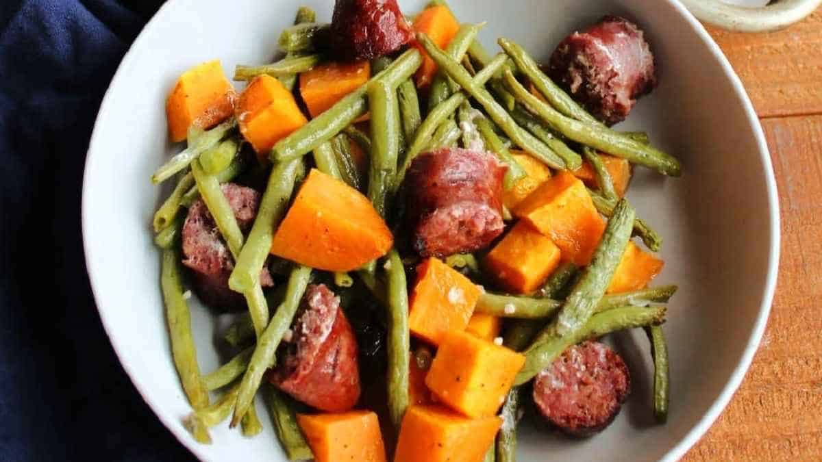 Green beans and sausage on a plate.