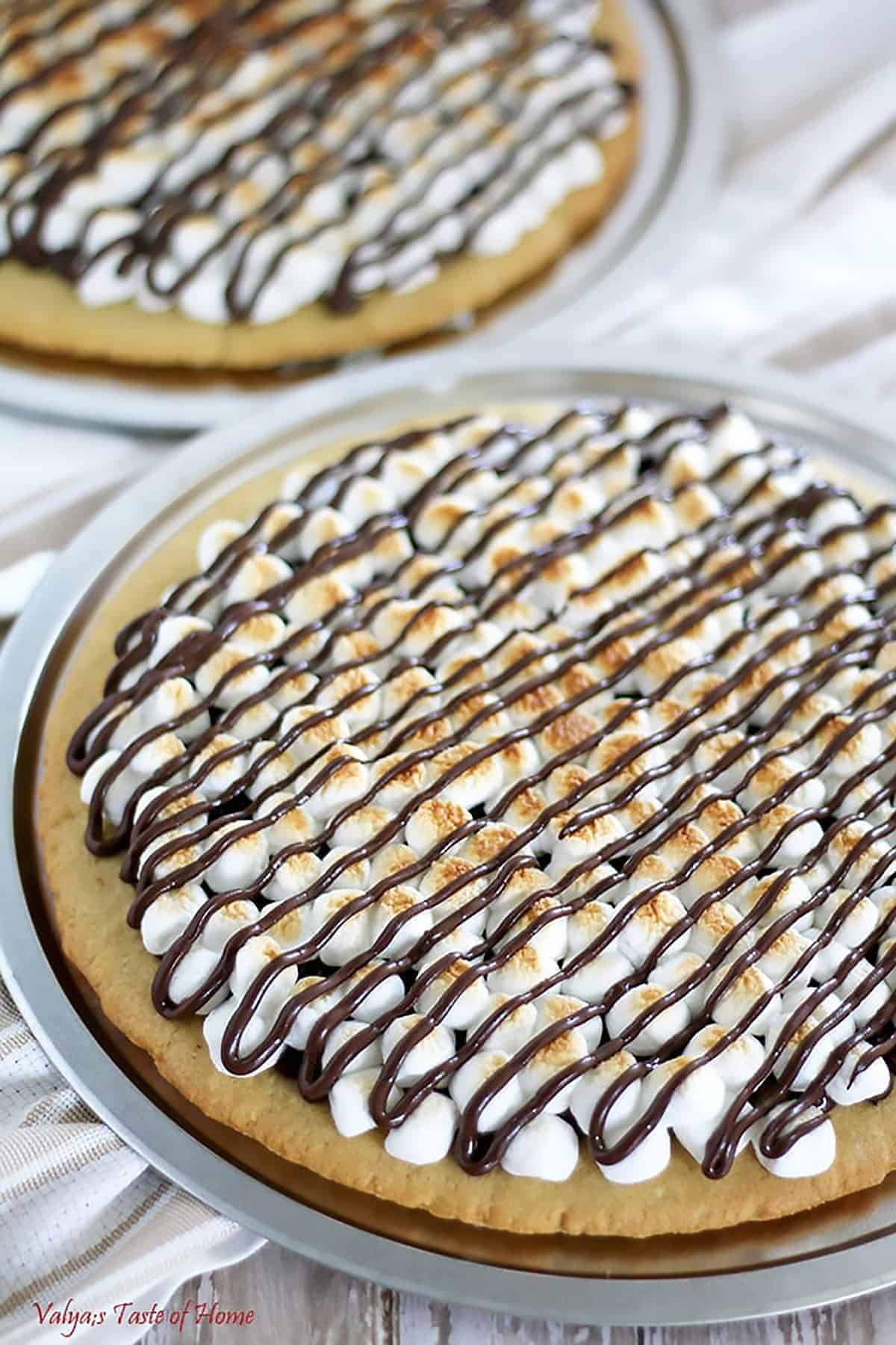 It features a homemade sugar cookie crust, with toasted mini marshmallows and melted chocolate chips to satisfy your sweet tooth. 
