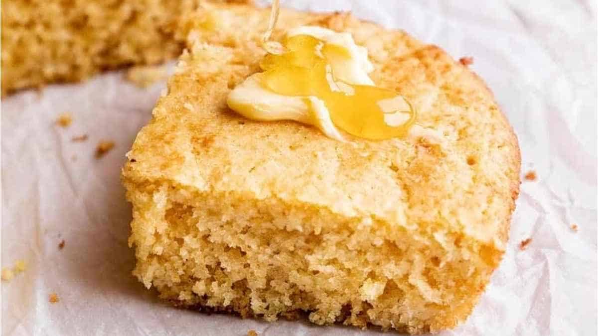 A slice of cornbread with butter on it.