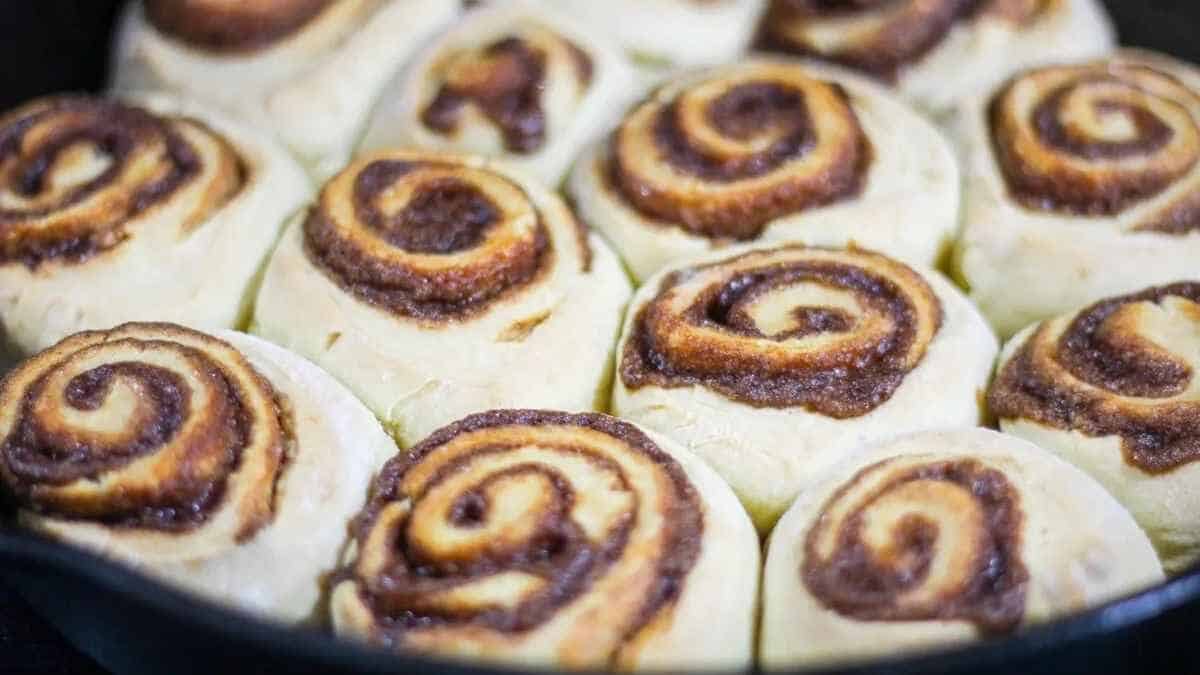Cinnamon rolls in a skillet on a table.
