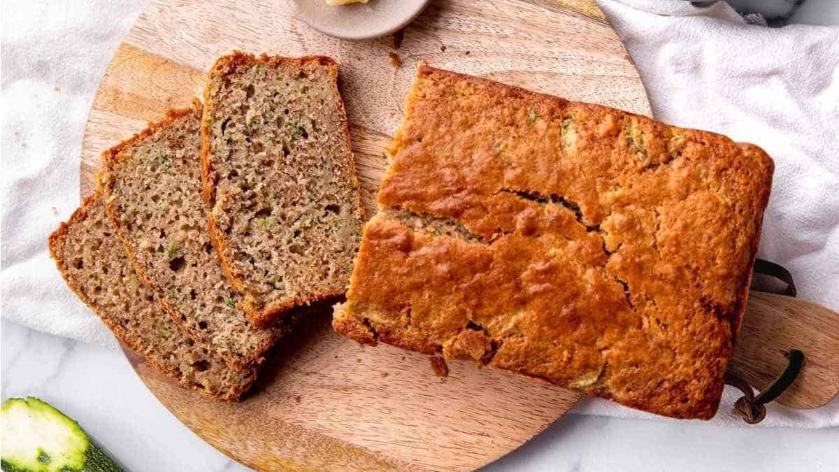 A slice of zucchini bread on a cutting board.