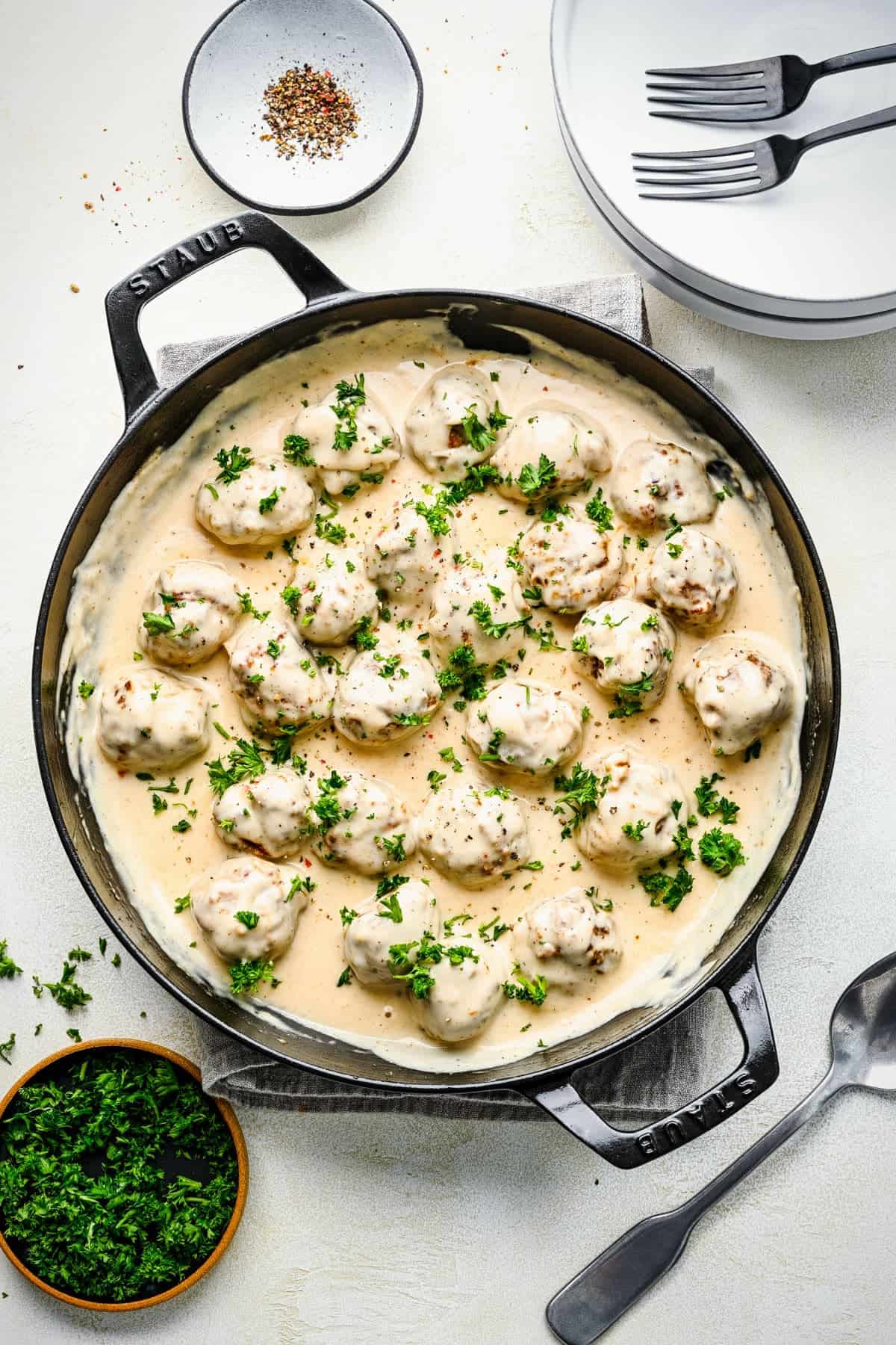 Chicken nuggets in cream sauce in a skillet.