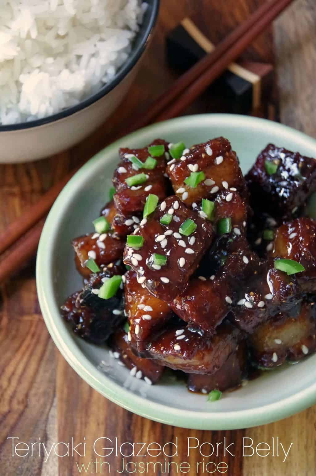 Delicious Japanese glazed pork belly recipe on a plate with rice and chopsticks.