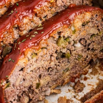 Meatloaf in a crock pot with ketchup.