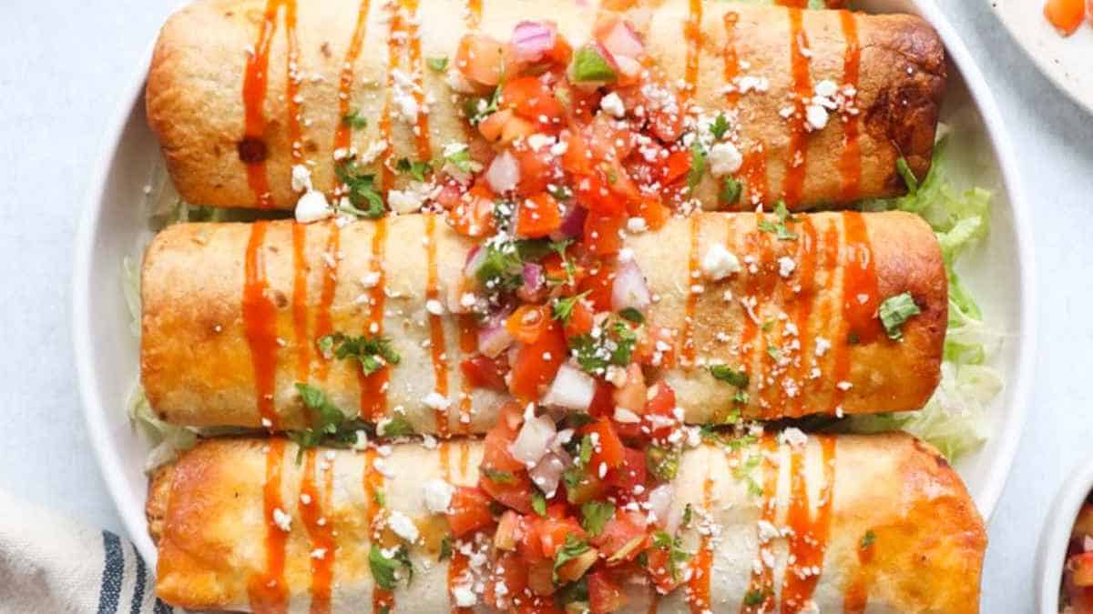 Mexican enchiladas on a white plate.