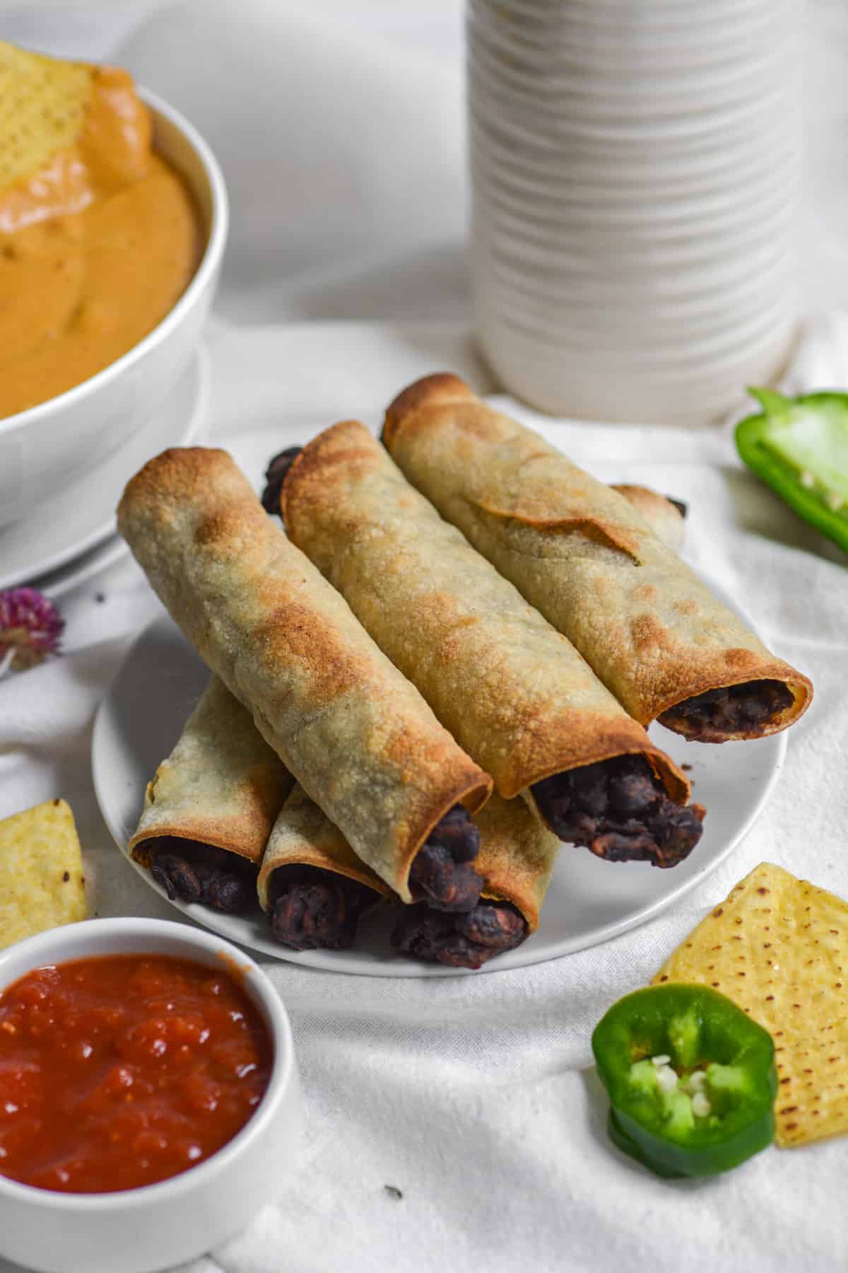 finished vegan gluten-free air fryer taquitos on a plate 
