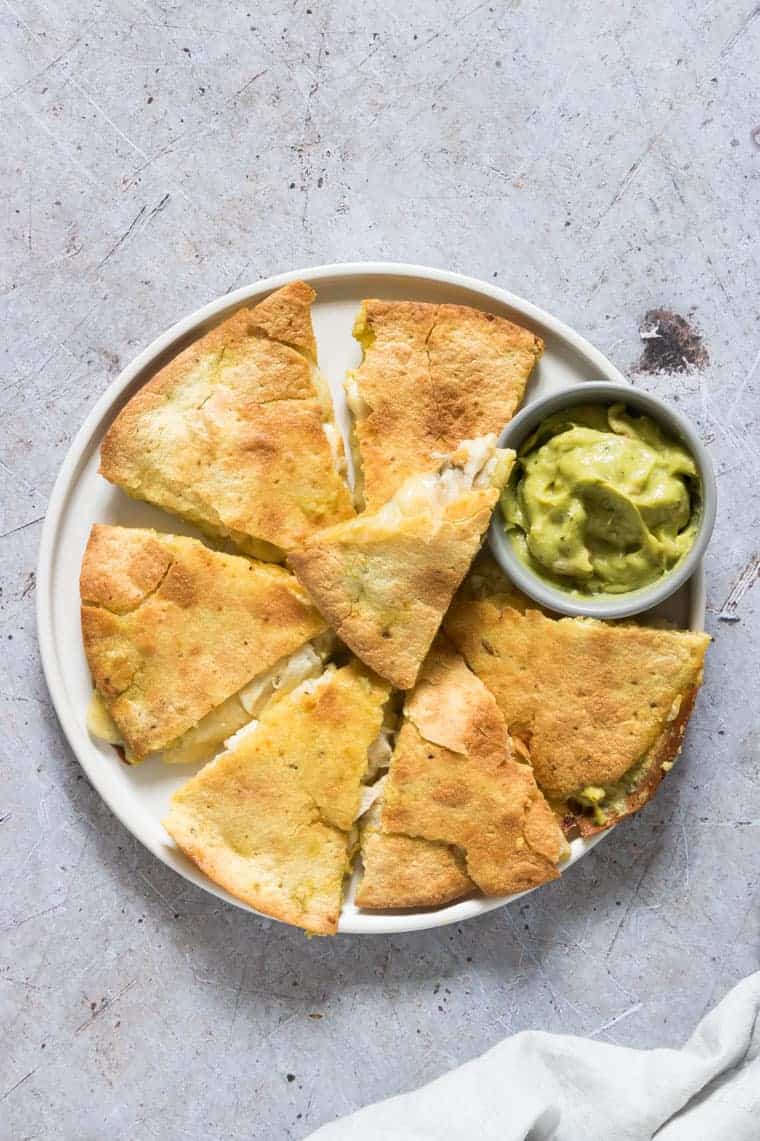 air fryer chicken quesadilla cut into pieces and served on a white plate.
