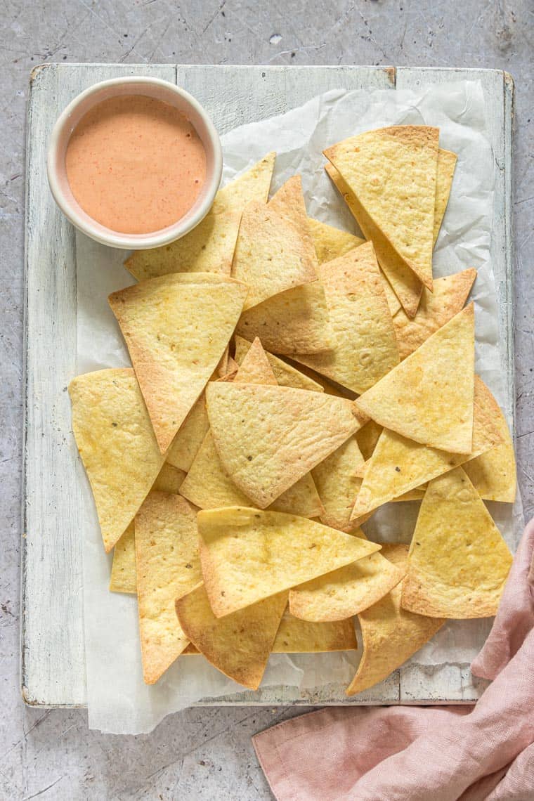 the finished air fryer tortilla chips served with dipping sauce.
