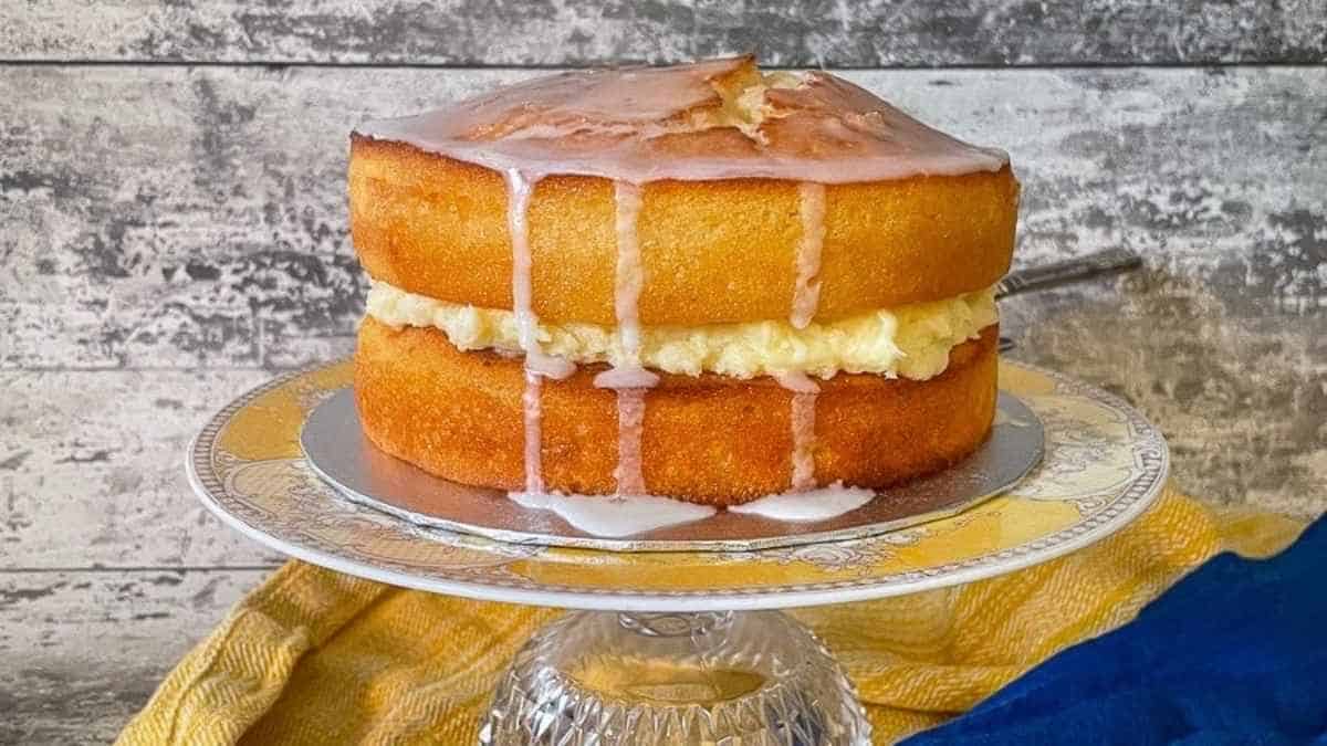 A lemon pound cake on a cake stand.