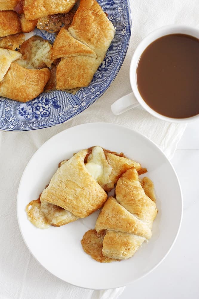 brown butter apple cheddar pie crescent rolls on plate.

