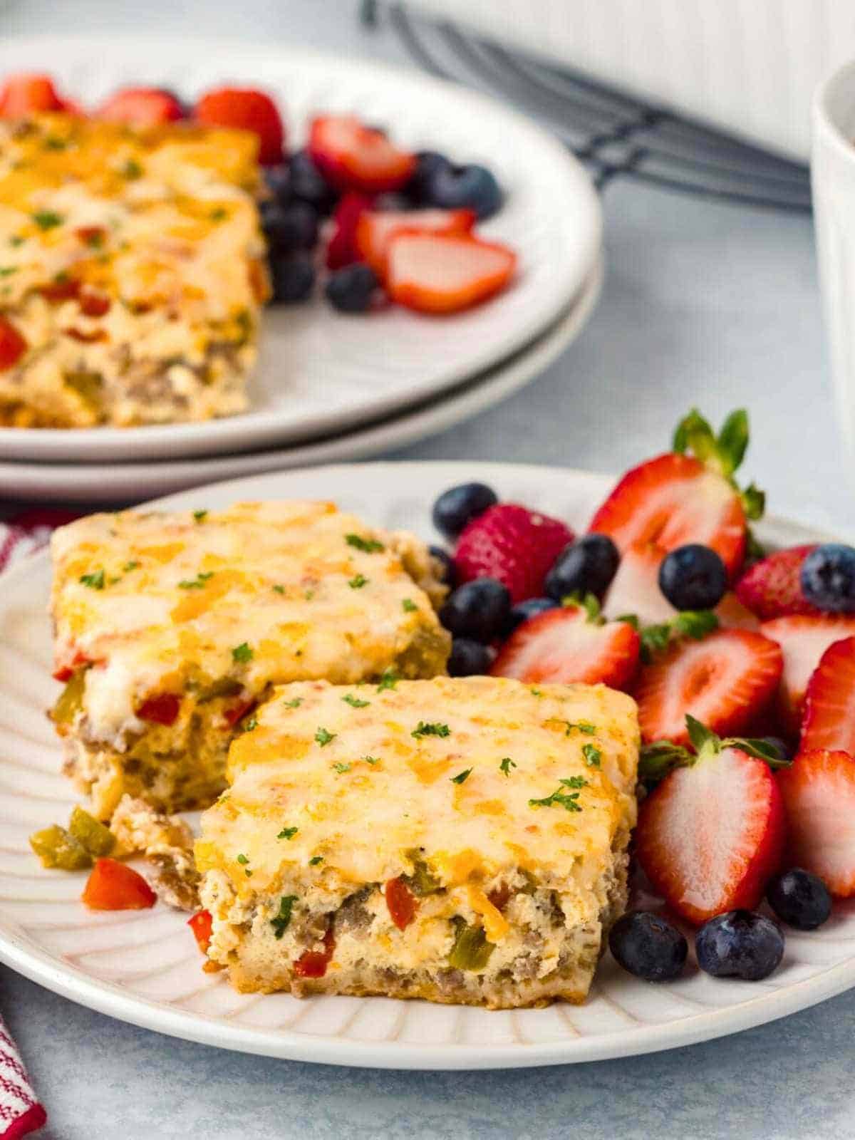 Crescent Roll Breakfast Casserole with strawberries and blueberries on a white pate. 
