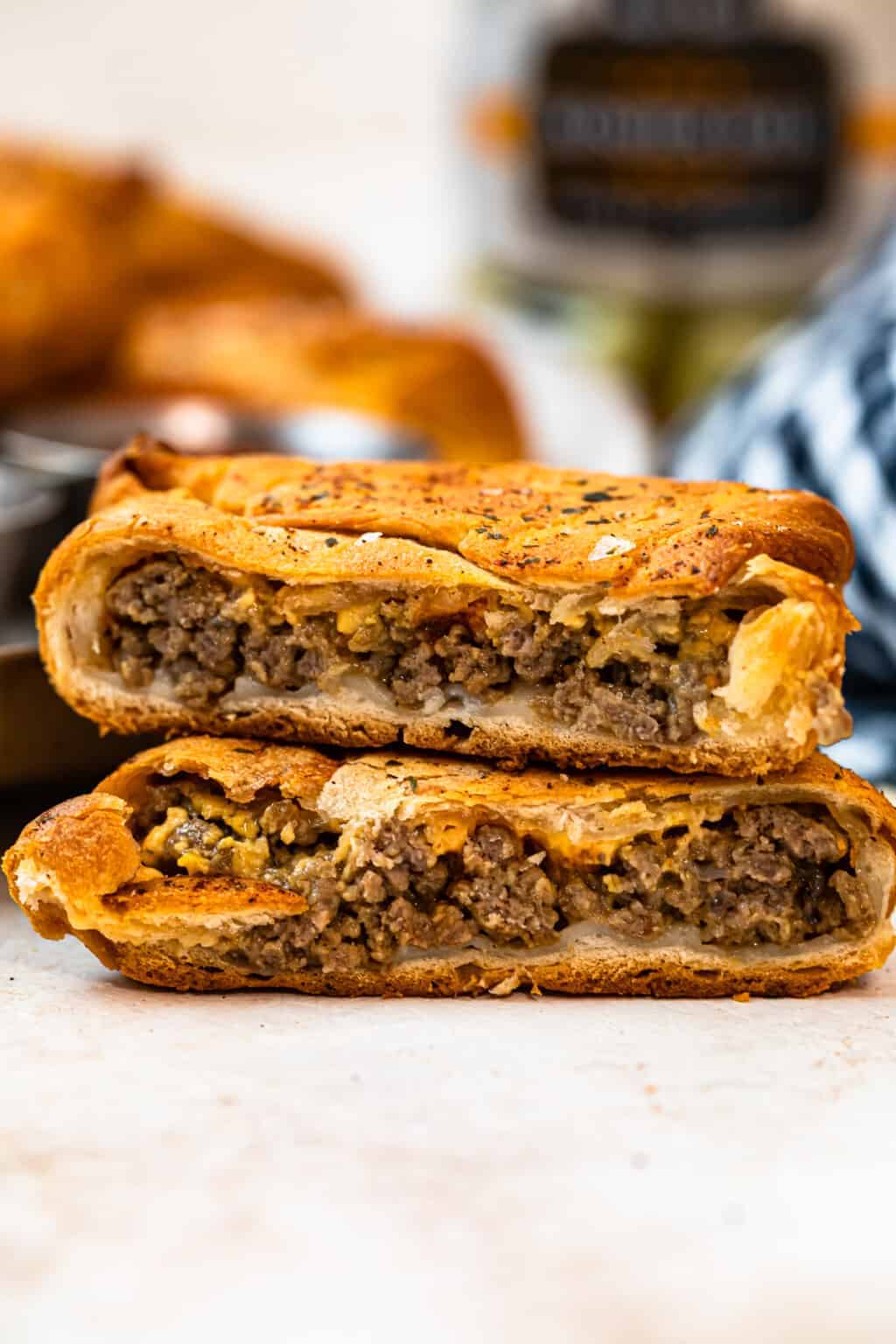 stacked cheeseburger hand pies showing the middle.
