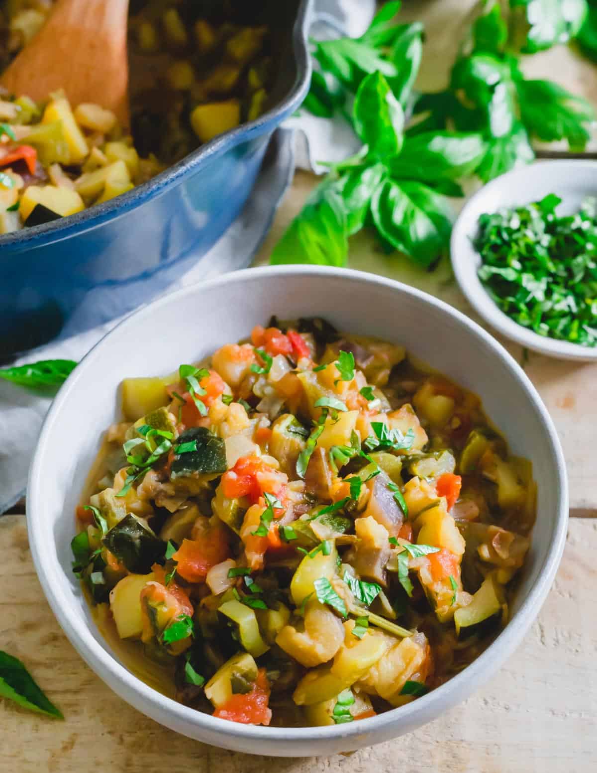 Ciambotta, Italian vegetable stew in a bowl with fresh basil. / Ciambotta, Italian vegetable stew in a bowl with fresh basil.
