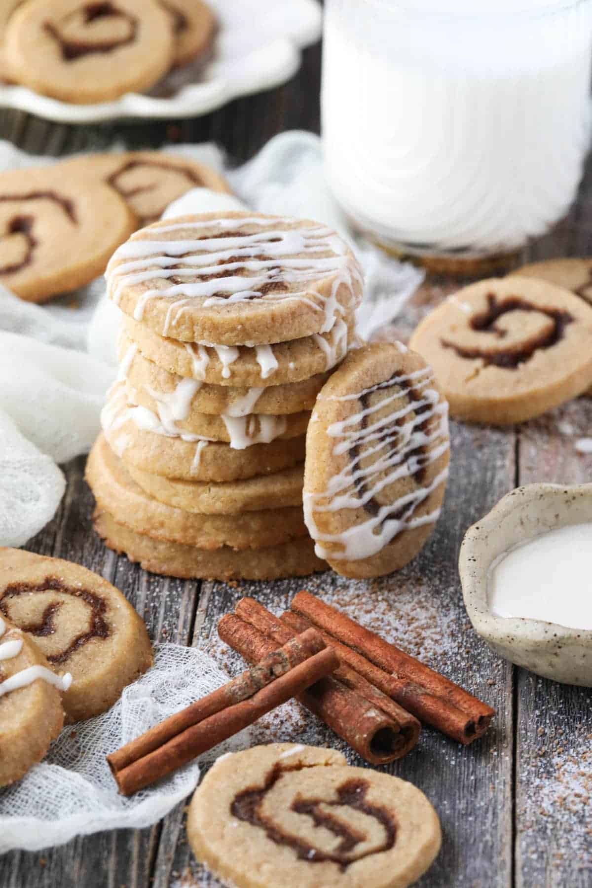 unique Cinnamon roll cookies with icing and cinnamon sticks.