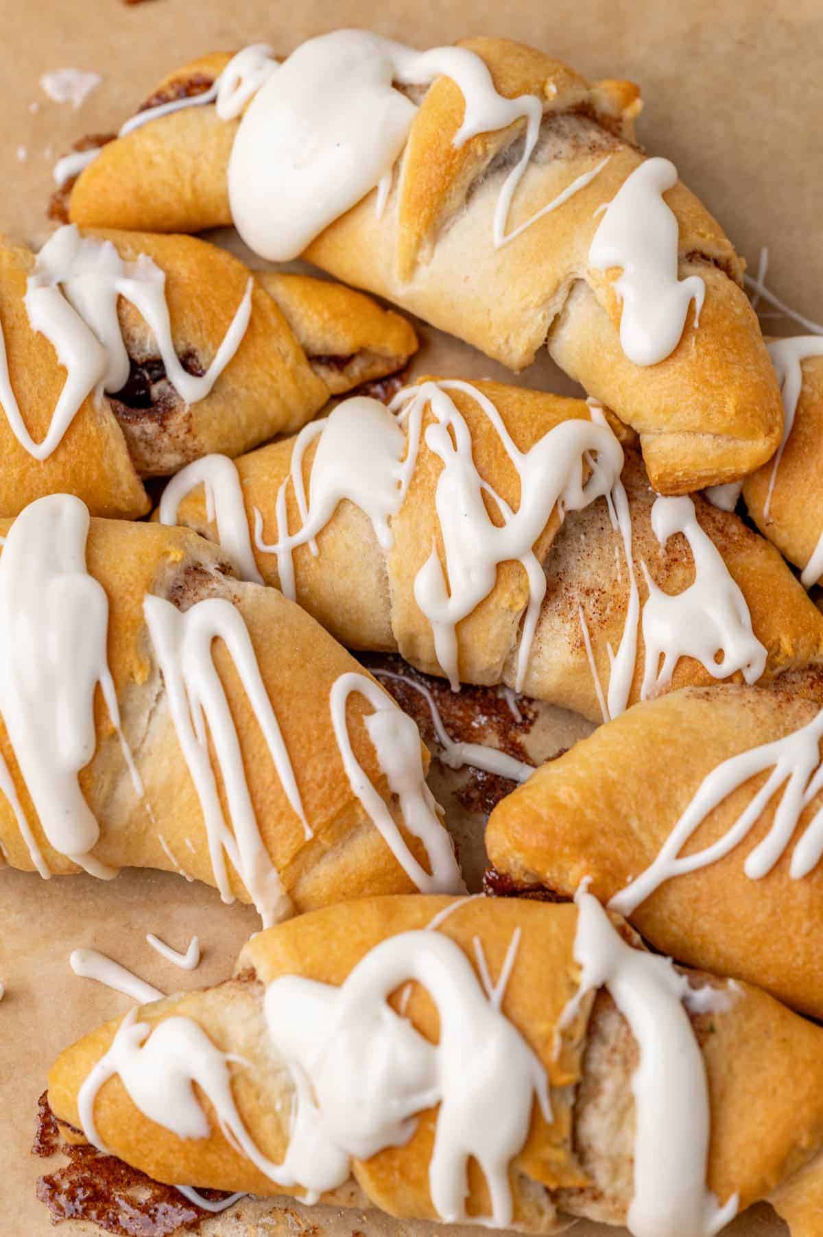 crescent roll cinnamon rolls with glaze on a table.
