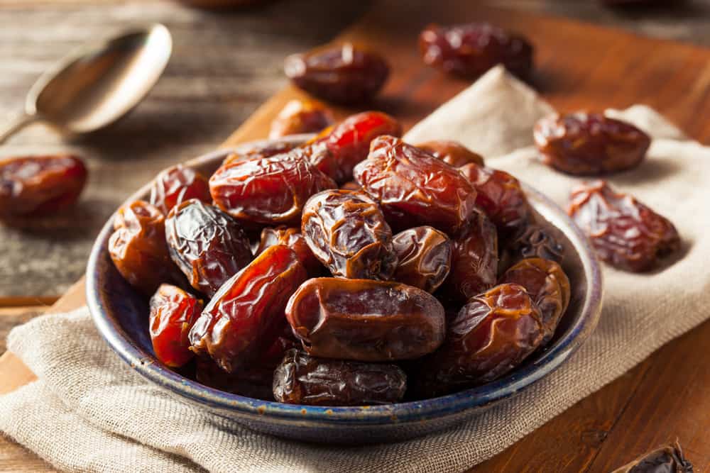 A bowl of delicious dates on a table.