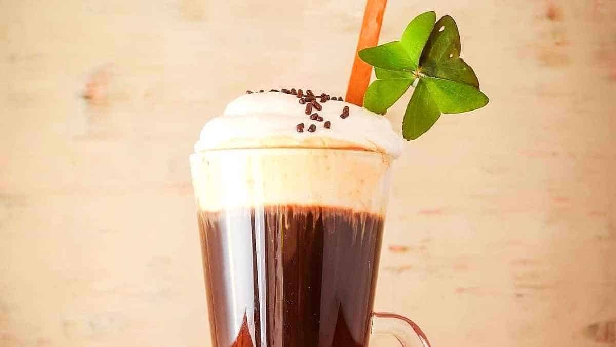 Irish coffee with whipped cream and shamrock leaves.