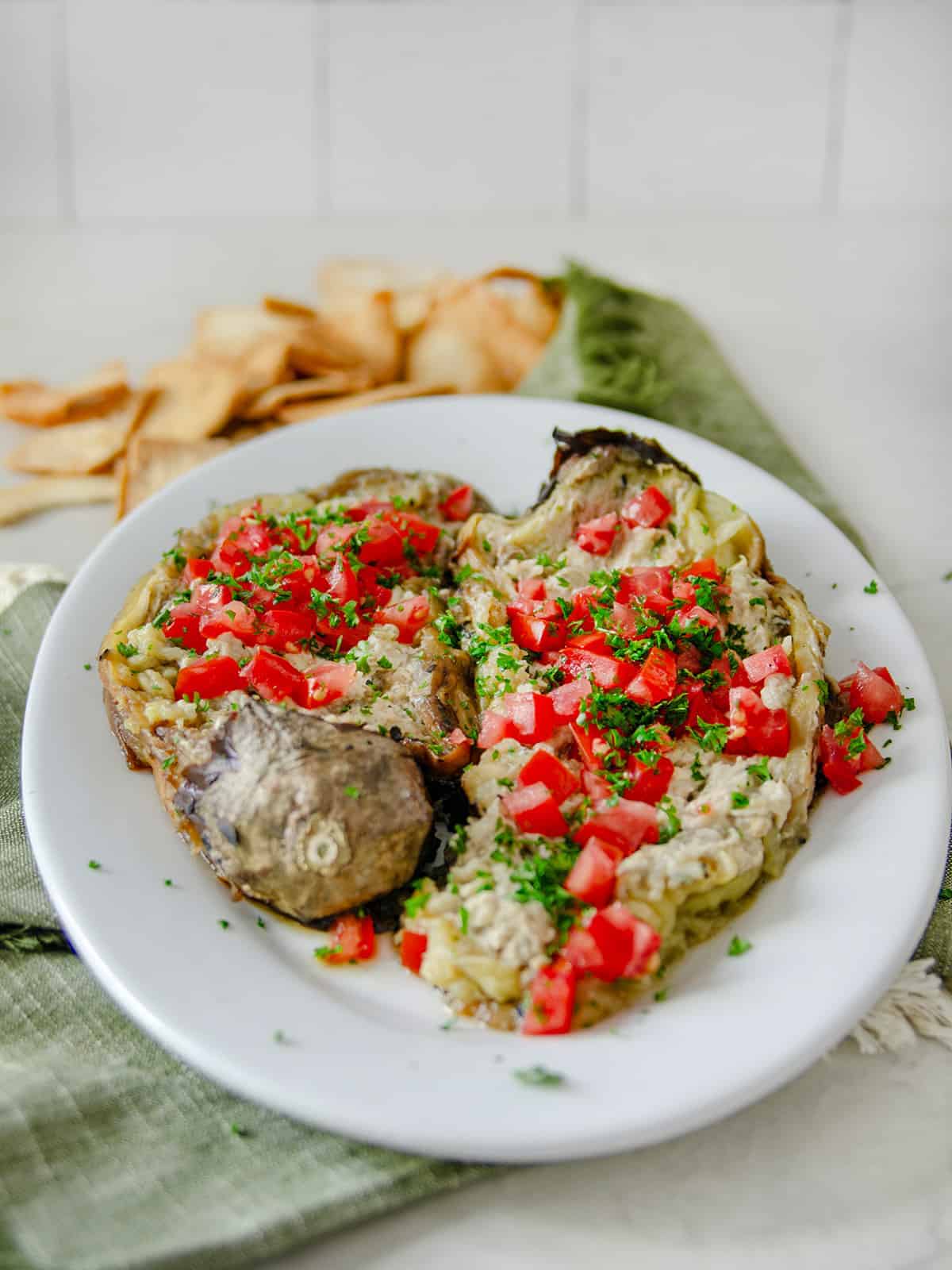 Eggplant dip topped with diced tomatoes and parsley. 
