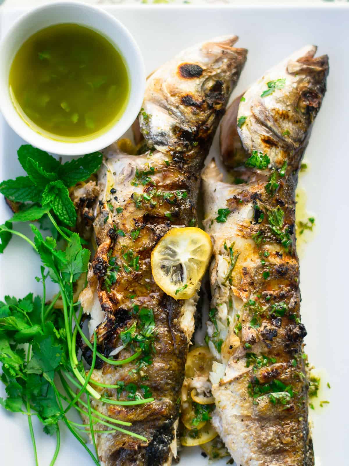 Whole grilled branzino with lemon and herbs. 
