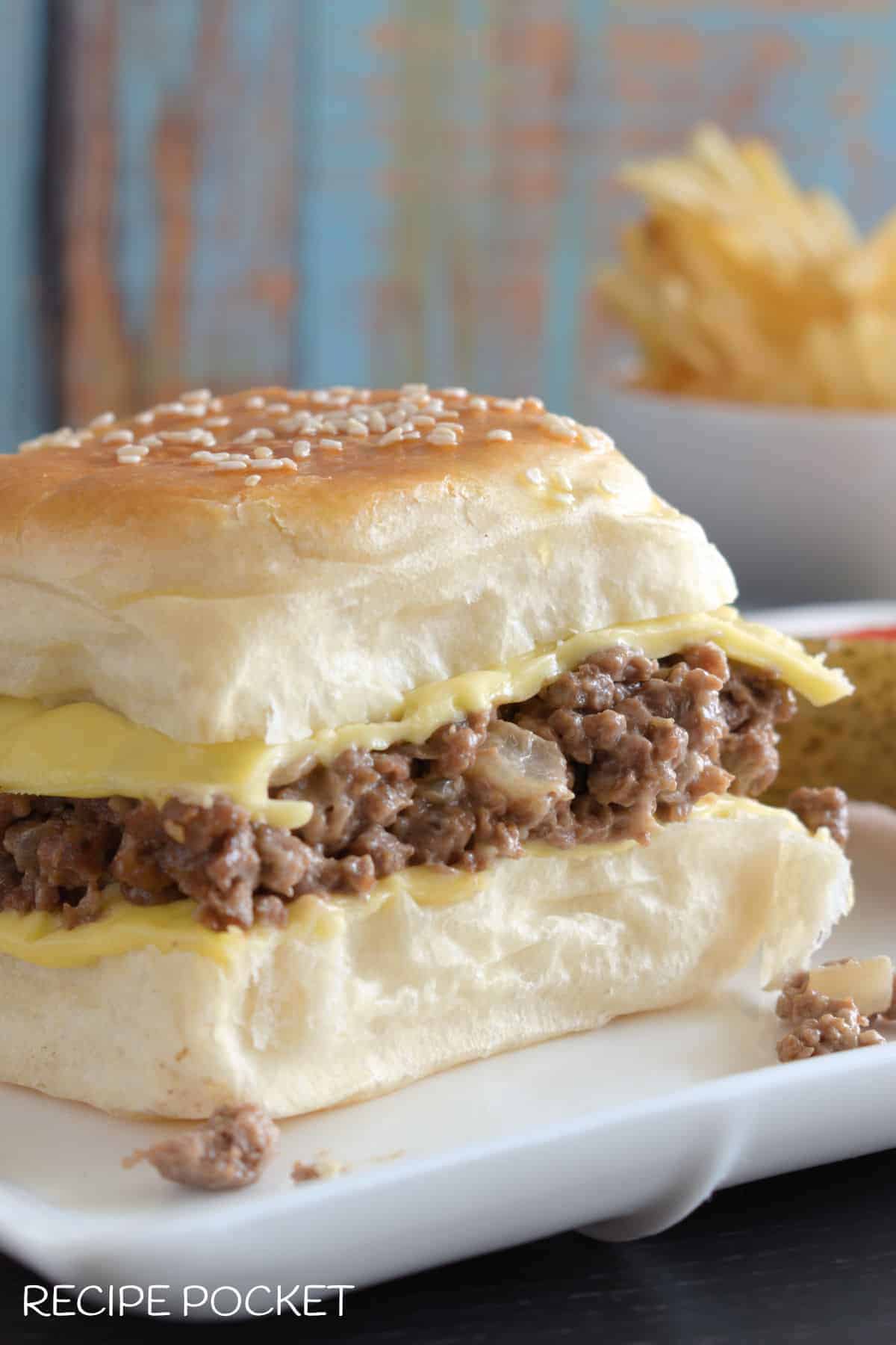 Close up of ground beef slider with onion soup mix on a white plate. 
