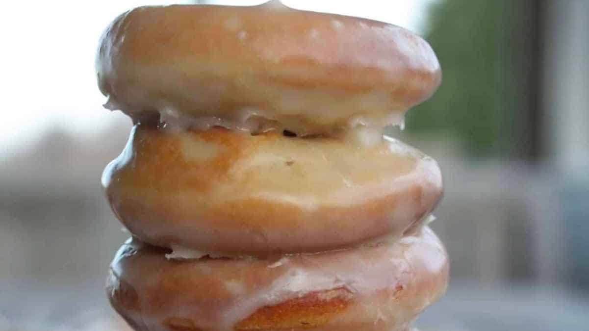 A stack of donuts on a plate.