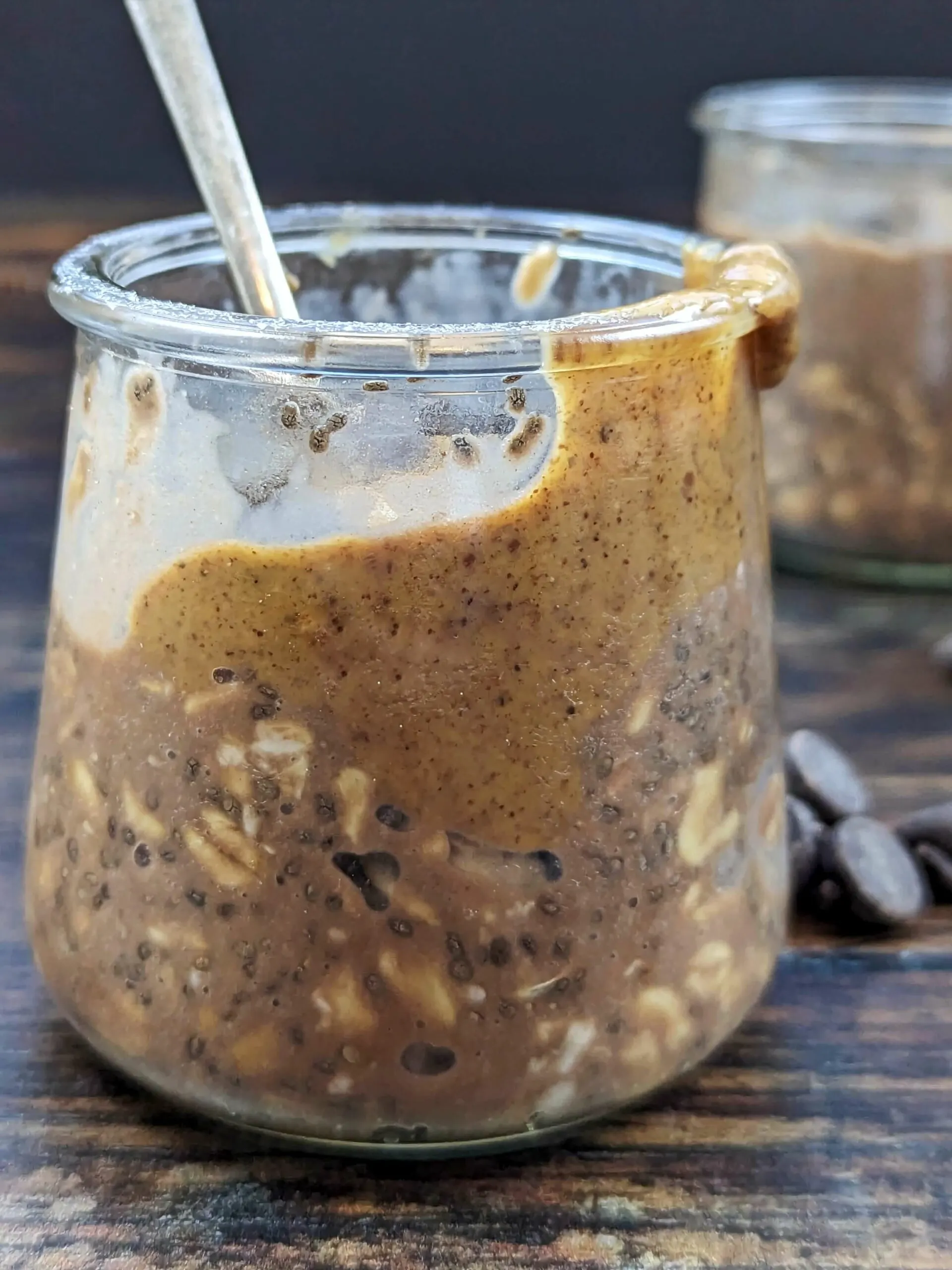 Two jars of high protein oatmeal with peanut butter and chocolate.
