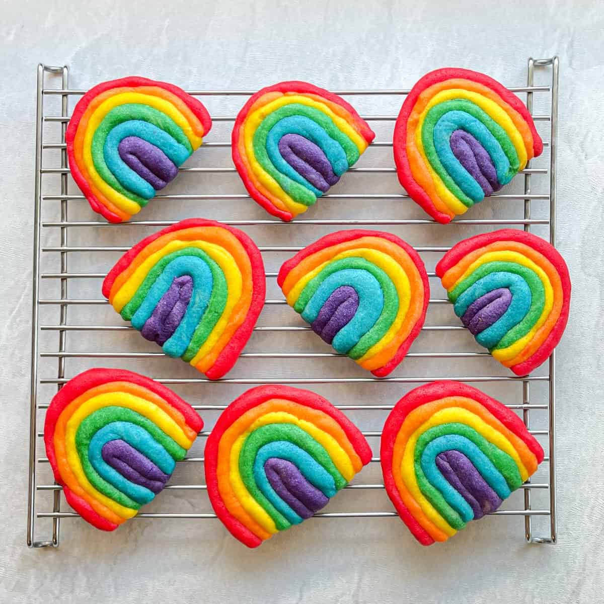 Rainbow cookies on a cooling rack showcasing unique cookie recipes.