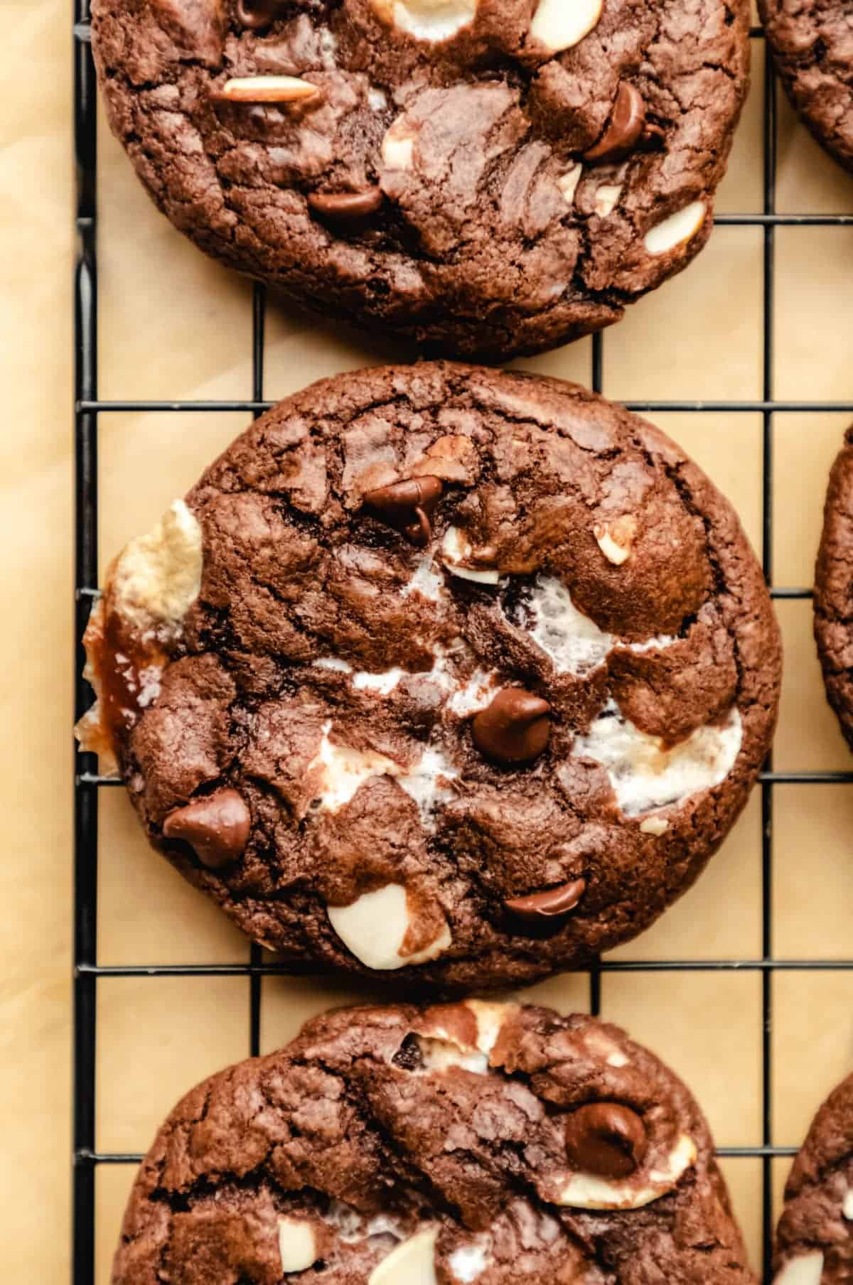 Unique chocolate chip cookies on a cooling rack.
