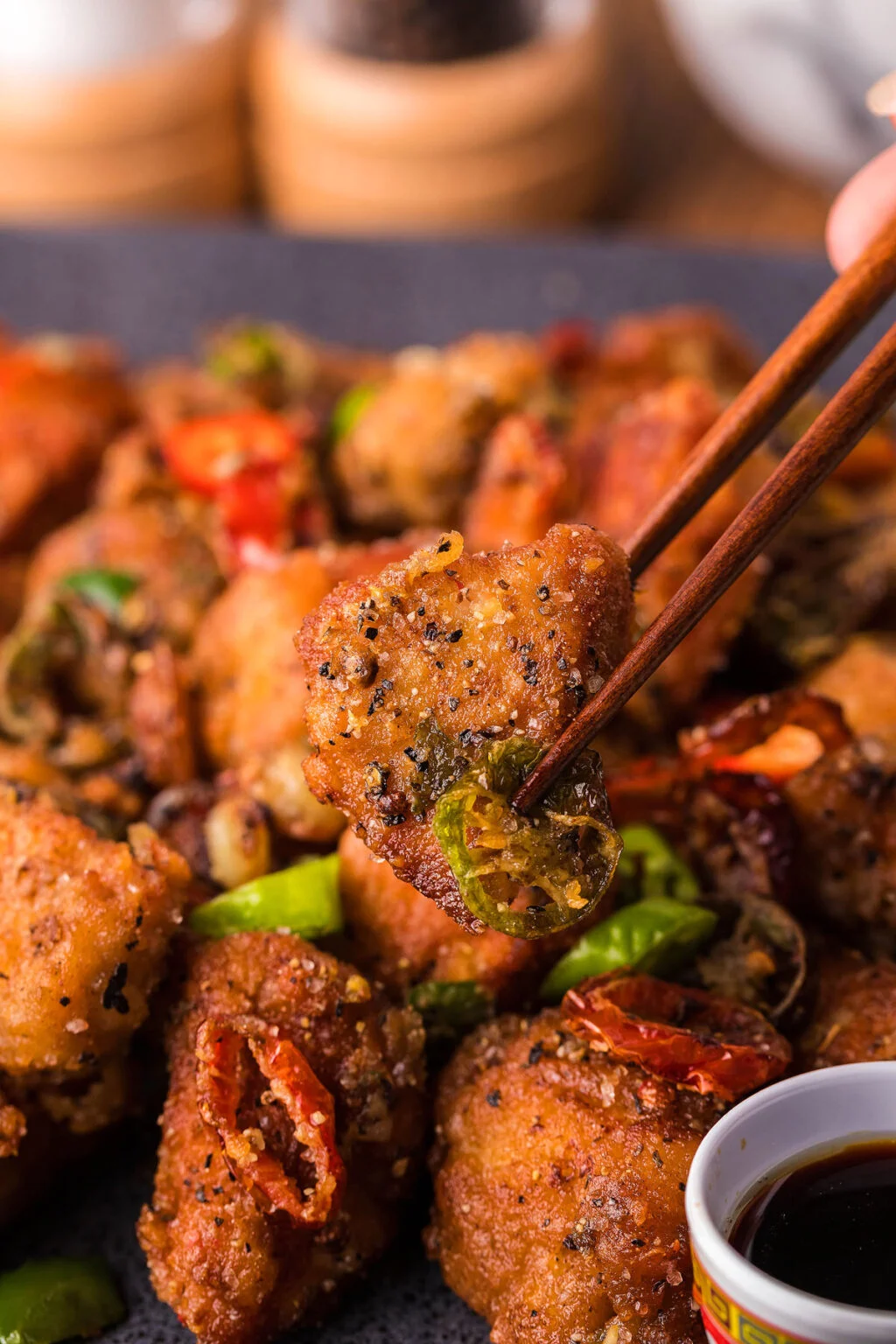 Chinese fried chicken with chopsticks on a plate.