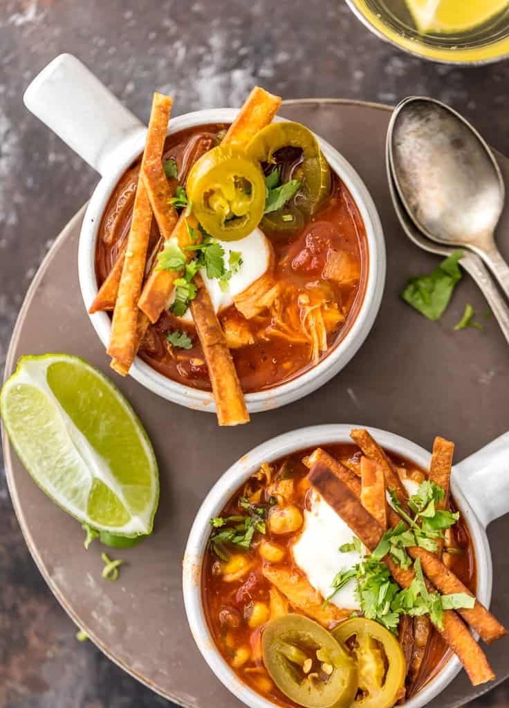 two bowls of slow cooker chicken tortilla soup / Slow Cooker Chicken Tortilla Soup (Healthy Crockpot Tortilla Soup) is my absolute FAVORITE SOUP recipe for Winter! This Chicken Tortilla Soup is spicy, easy, and delicious. This Healthy Chicken Tortilla Soup is loaded with spices, chicken, tomatoes, green chiles, corn, and more! It's so simple and delicious. Best Chicken Tortilla Soup in a Slow Cooker!
