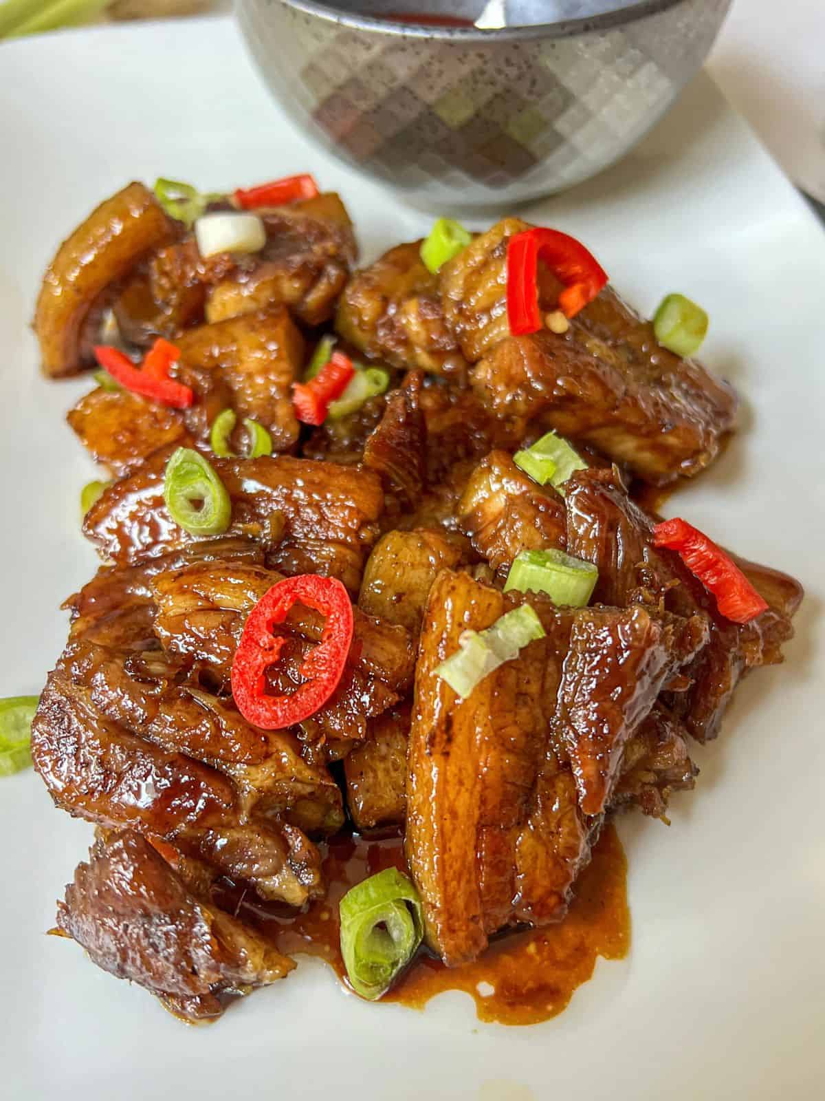 A plate of Chinese pork belly ribs on a white plate.